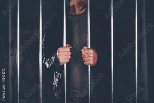 Canvas Print Man behind prison bars