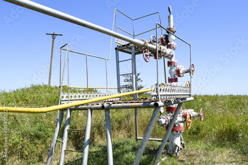 Well for oil and gas production. Oil well wellhead equipment. Oil production © eleonimages