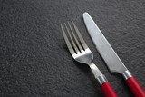 Fork and butter knife on black background
