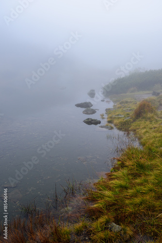 misty morning view in wet mountain area in slovakian tatra. mountain lake panorama