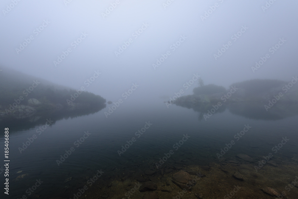 misty morning view in wet mountain area in slovakian tatra. mountain lake panorama misty morning view in wet mountain area in slovakian tatra. mountain lake panorama
