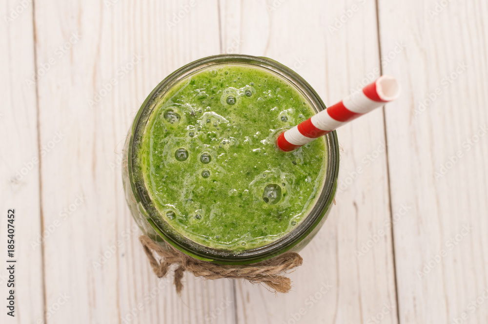 healthy green smoothie with banana, spinach, avocado and kiwi in a glass bottles on a rustic healthy green smoothie with banana, spinach, avocado and kiwi in a glass bottles on a rustic