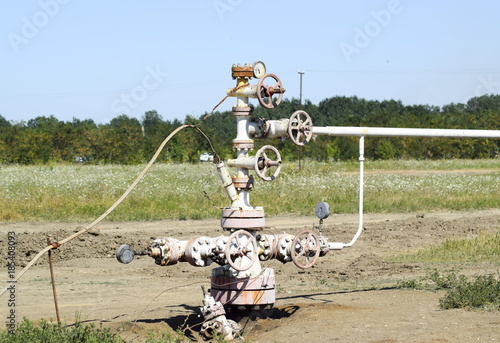 Well for oil and gas production. Oil well wellhead equipment. Oil production photo