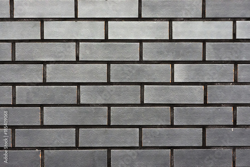 A brick wall of grey colour, texture, background.