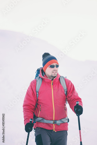 A man in snowshoes in the mountains.