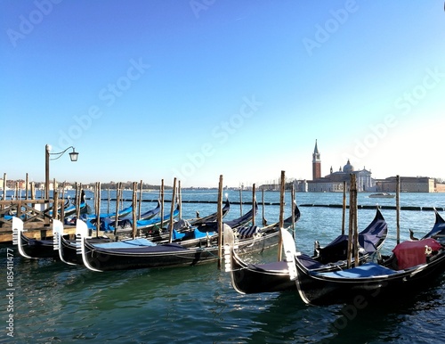 VENICE, ITALY - DECEMBER 20, 2017 : gondolas parked in front of san Marco plaza harbor in Venice city center. © Photographer