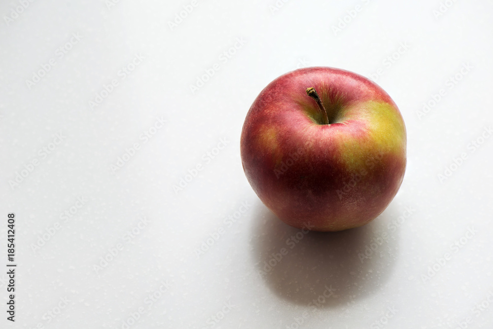 Red and yellow apple contrast lighting on white background