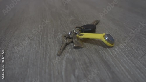 the hand of the young man puts on the table a keys,concept of the person comes home.