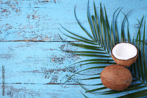 Coconuts with leafs on blue wooden table