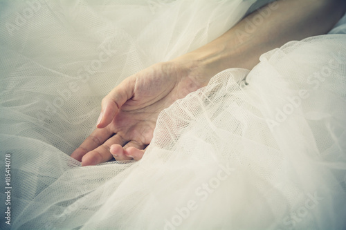 Female hand over tulle fabric background - Bride concept - Femininity, sorority concept - Simple life, skin care, medical treatment, blood donation - Humanitarian help