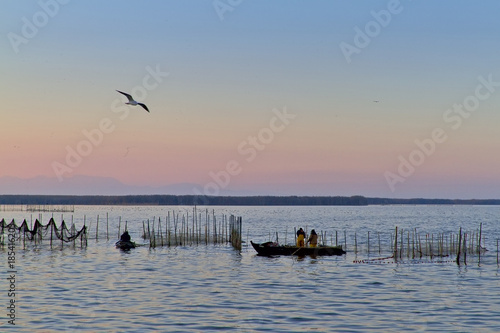 Fishermen on the lake of La Albufera at dawn. © Salva G. Cubells