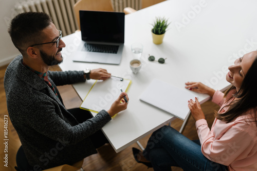 Recruiter and job candidate both smiling at job interview