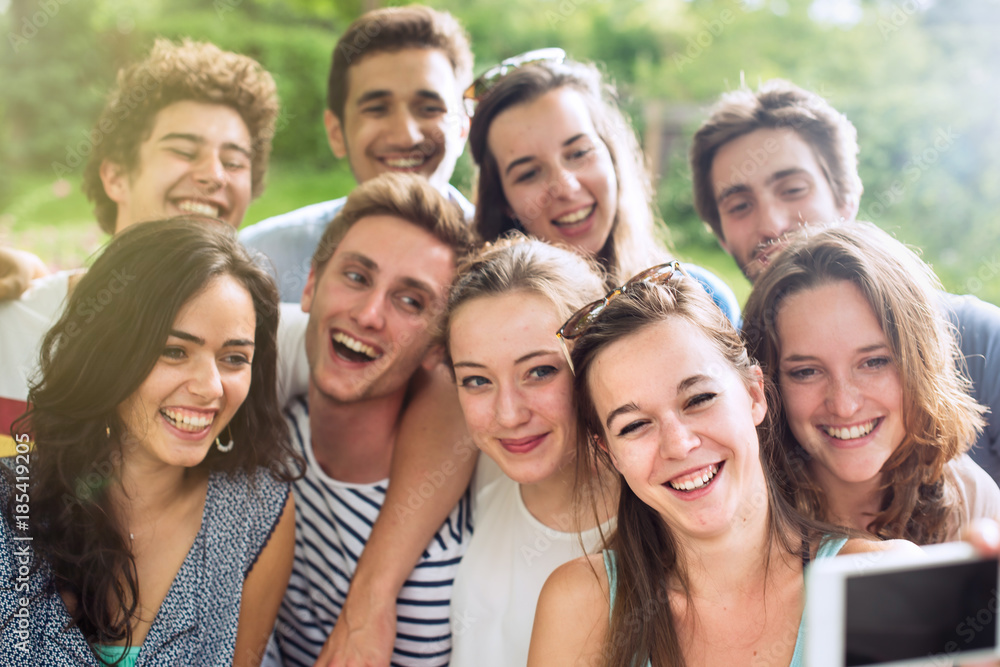 Group of young people taking a selfie outside