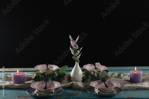 Fototapeta Naklejka Na Ścianę i Meble -  Elegance table setting with flower vase and lit candle
