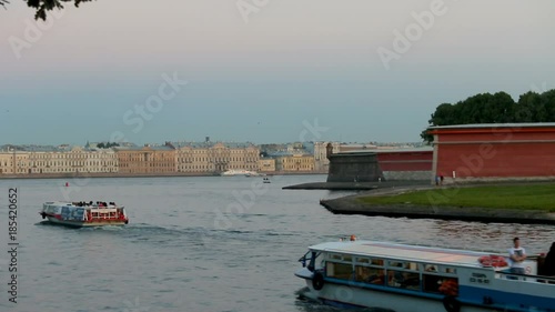 Peter and Paul Fortress, Zajachij island, tourists boats cross the river Neva photo