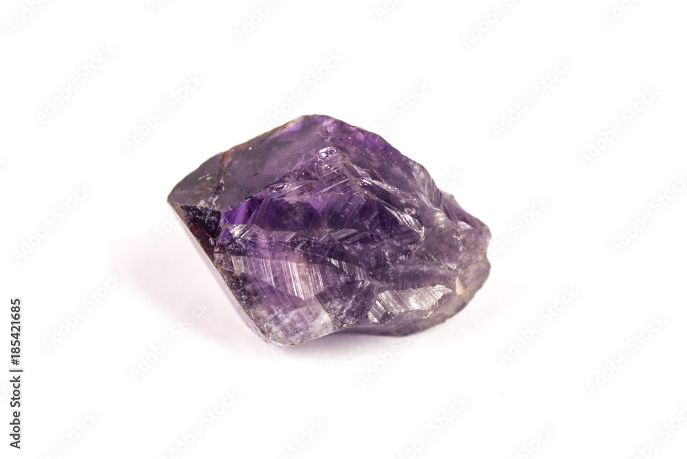 Raw purple crystal stone isolated on white background