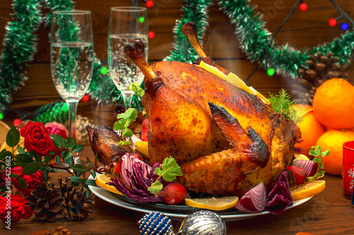 Christmas Dinner. Roasted chicken. Winter Holiday table served. Wooden background. Close-up. Top view