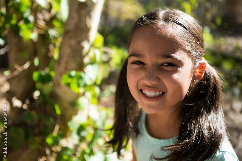 Portrait of happy little girl in the forest on a sunny day Portrait of happy little girl in the forest on a sunny day