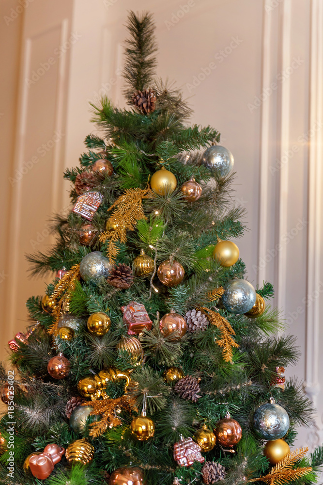 Classic christmas and New Year decorated interior room with presents and New year tree. Christmas tree with gold, blue and silver decorations
