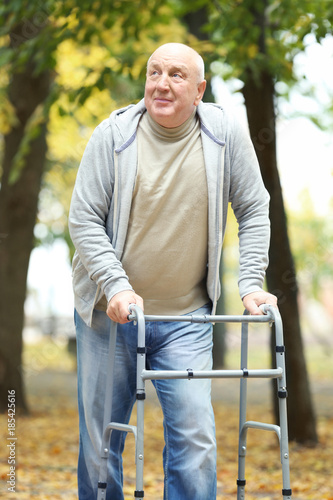 Elderly man with walking fr...