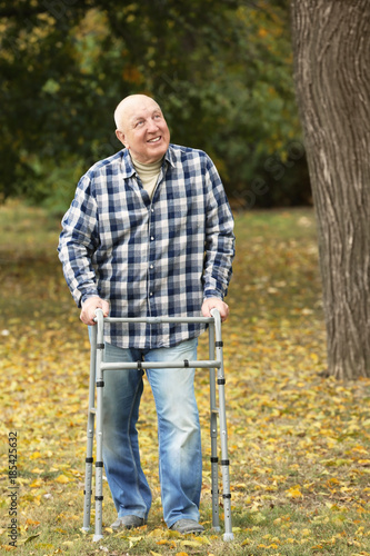 Elderly man with walking fr...