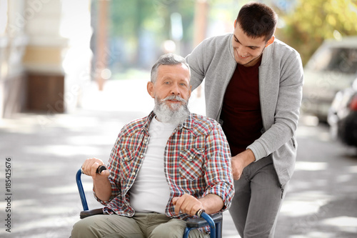 Young caregiver walking wit...