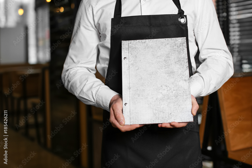 Waiter holding menu in restaurant Stock Photo Adobe Stock