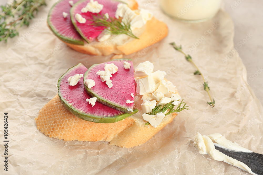 Delicious bruschetta with radish on table, closeup