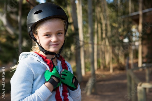 Portrait of little girl wearing helmet, harness and hand gloves © wavebreak3
