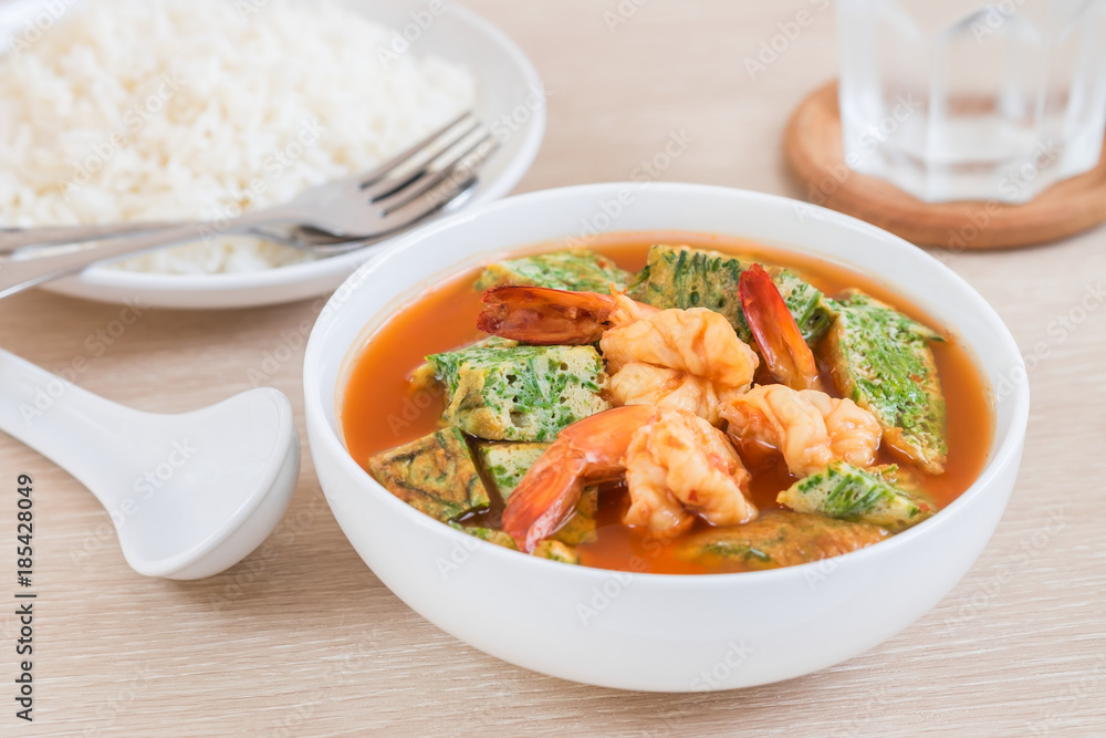 Acacia leave omelet and shrimp in spicy sour soup and rice on plate, Thai food Acacia leave omelet and shrimp in spicy sour soup and rice on plate, Thai food