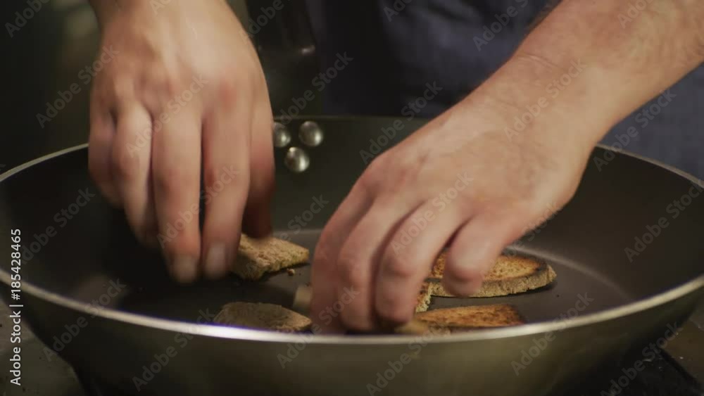 Chef is toasting rue bread in a pan Chef is toasting rue bread in a pan