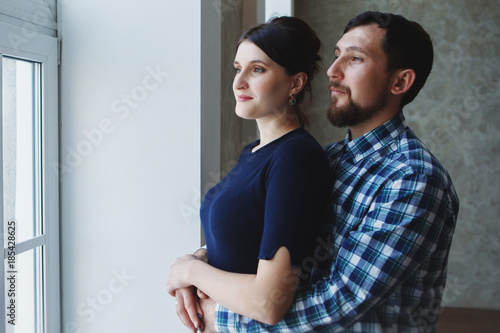 Happy couple over grey wall