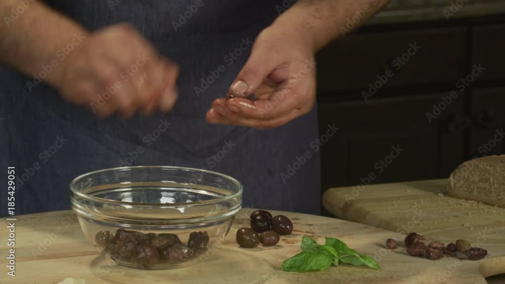 Chef is making olive, basil & fresh cheese spread Chef is making olive, basil & fresh cheese spread