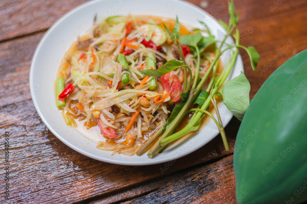 Thai food Papaya salad Spicy flavor On the old wood table Thai food Papaya salad Spicy flavor On the old wood table