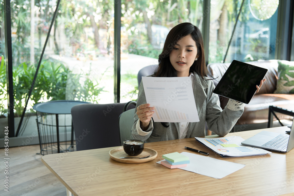 businesswoman using tablet computer at workplace. startup woman working with business plan report document at office. young female entrepreneur analyze accounting market chart & graph. businesswoman using tablet computer at workplace. startup woman working with business plan report document at office. young female entrepreneur analyze accounting market chart & graph.