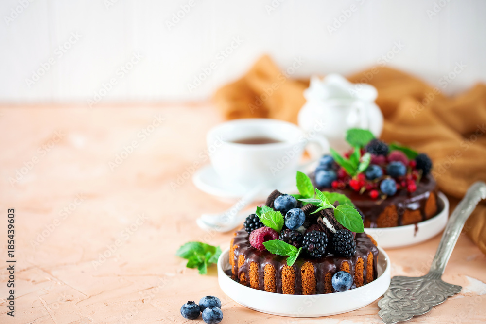 Cake in chocolate glaze with berries. Selective focus. Sweet summer dessert. Cake in chocolate glaze with berries. Selective focus. Sweet summer dessert.