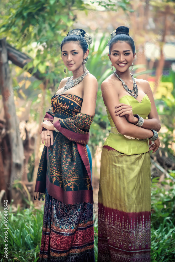 Two girl wears a local costume made of Thai silk.