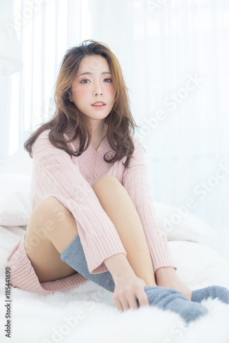 Asian Woman wake up on bed with happy emotion, People lifestyle concept.