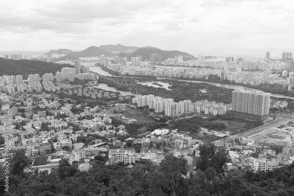 View of the city and the Sanya River from the observation deck in Linchunling Forest Park - black and white