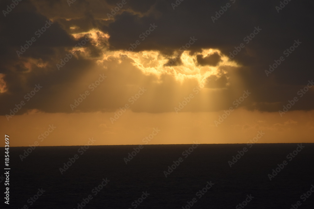 Fototapeta premium Sun Rays Peering from Dark Clouds