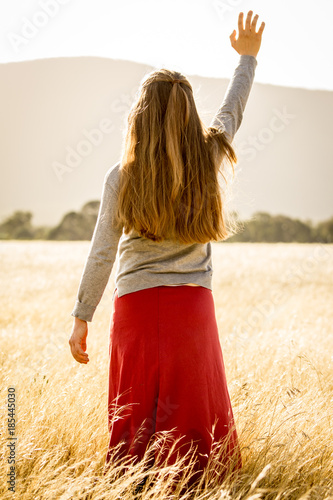 Girl raising hands in praise