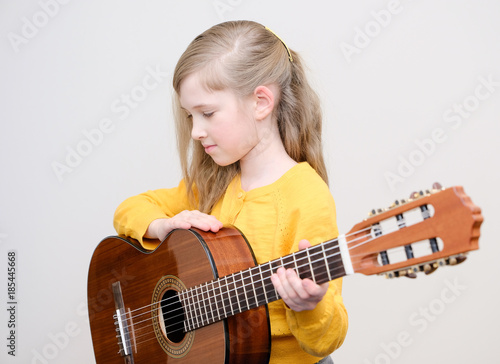 Girl playing acustic guitar