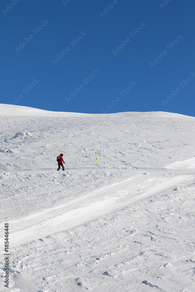 Snowboarder downhill on snowy slope