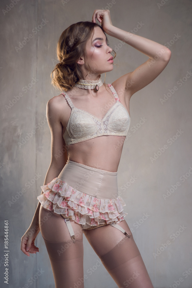 Lady in white vintage retro lingerie posing at foto de Stock | Adobe Stock