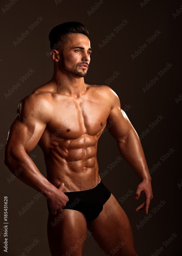 Athletic bodybuilder man on black background. Athletic bodybuilder man on black background.