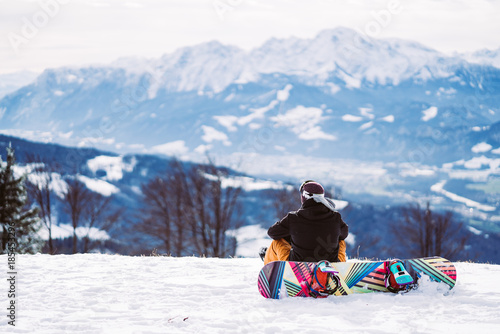 Snowboarder looking at the winter landscape in Austria