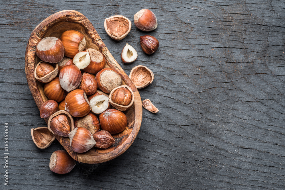Filberts or hazelnuts in the wooden bowl on the table. Filberts or hazelnuts in the wooden bowl on the table.
