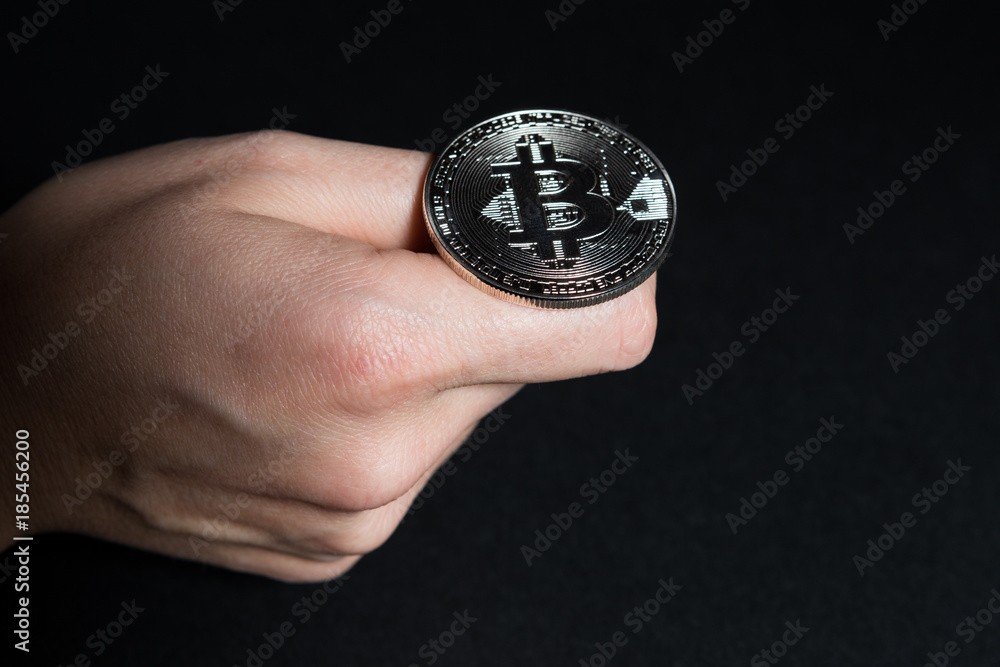 Woman hand flipping a bitcoin