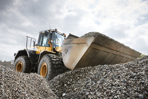 Excavator moving sand
