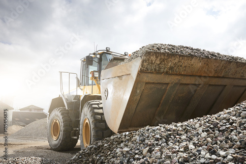 Excavator moving sand